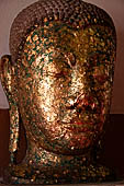 Ayutthaya, Thailand. Viharn Phra Mongkhon Bophit, Buddha heads covered in gold leaves.